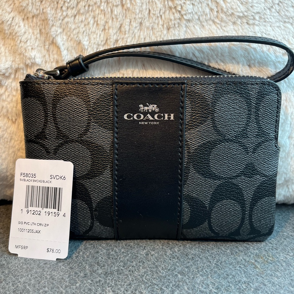 Coach wristlet 
Corner zip wristlet on black signature canvas